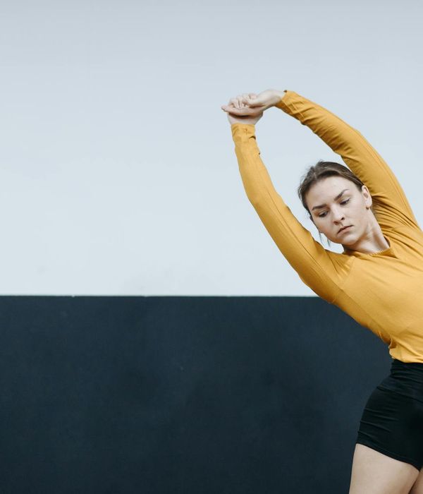 Person balancing gracefully in a bright, minimalist space.